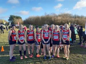 Striders ladies fly flag at cross country