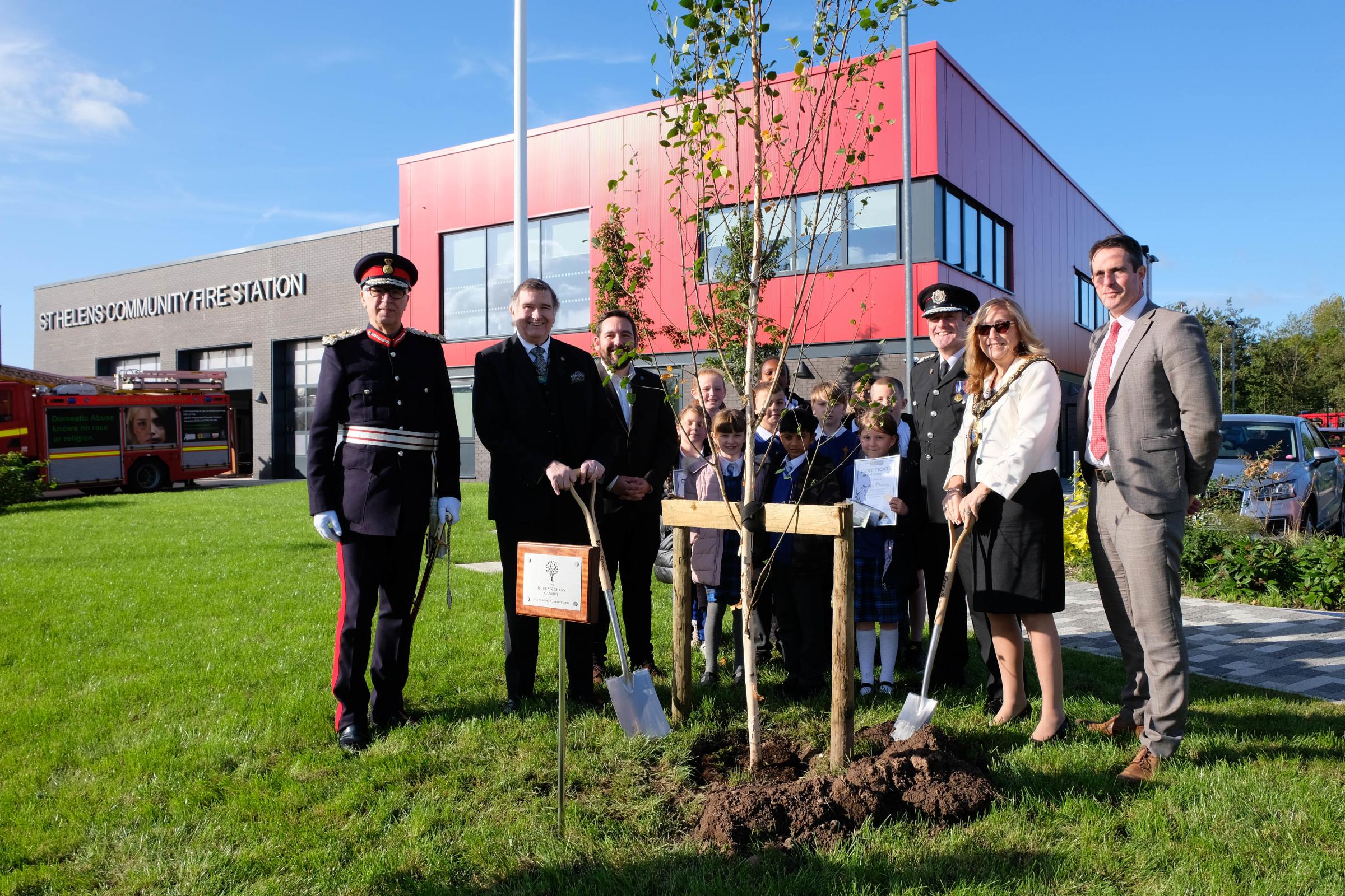 The tree planting as part of Queen’s Green Canopy Platinum Jubilee celebrations Pictured are: Lord Lieutenant of Merseyside, chair of the fire authority Cllr Les Byrom; council leader David Baines; pupils from Holy Cross Primary School; chief fire