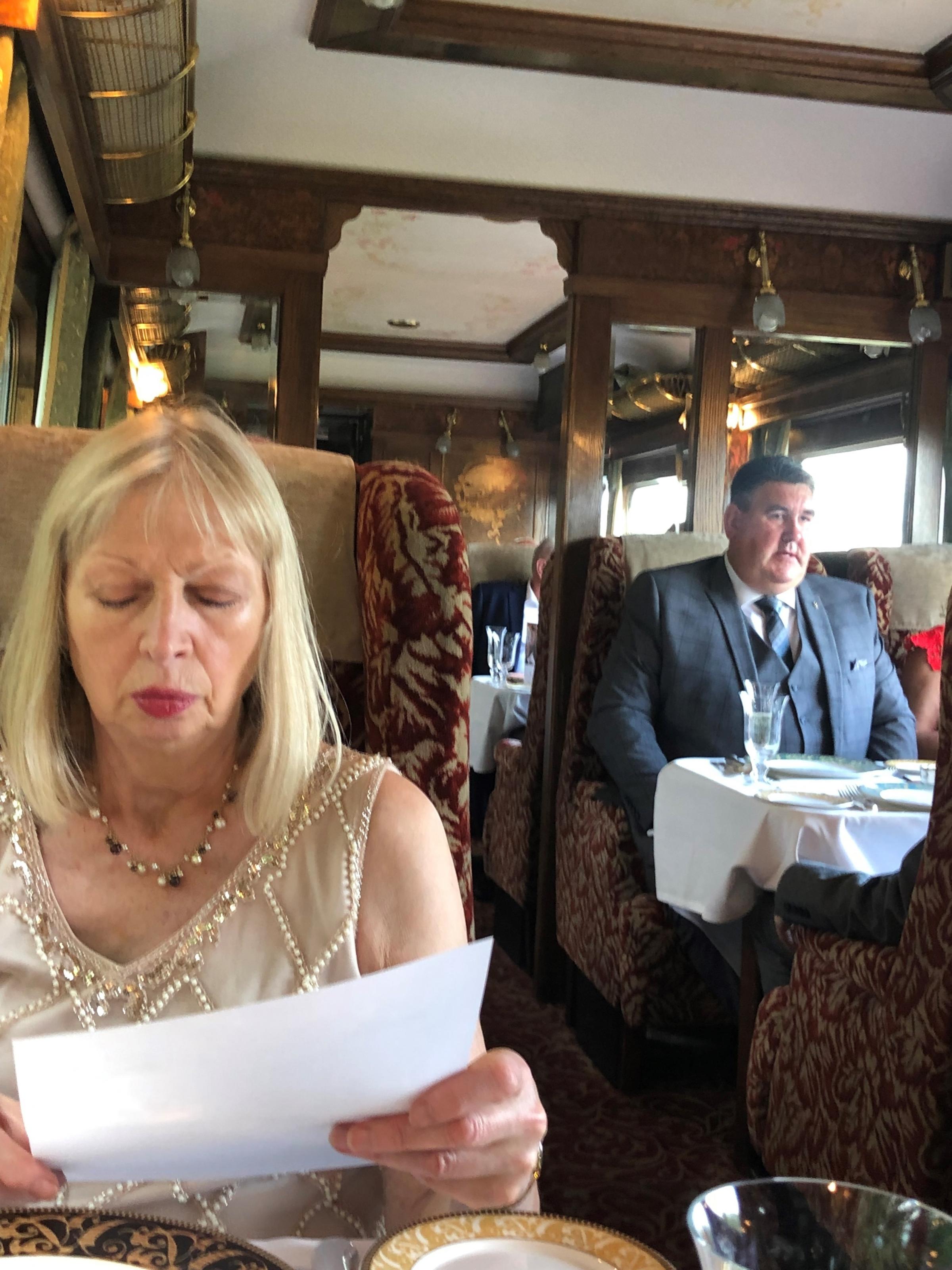 Diners study the menu before dinner aboard the Northern Belle