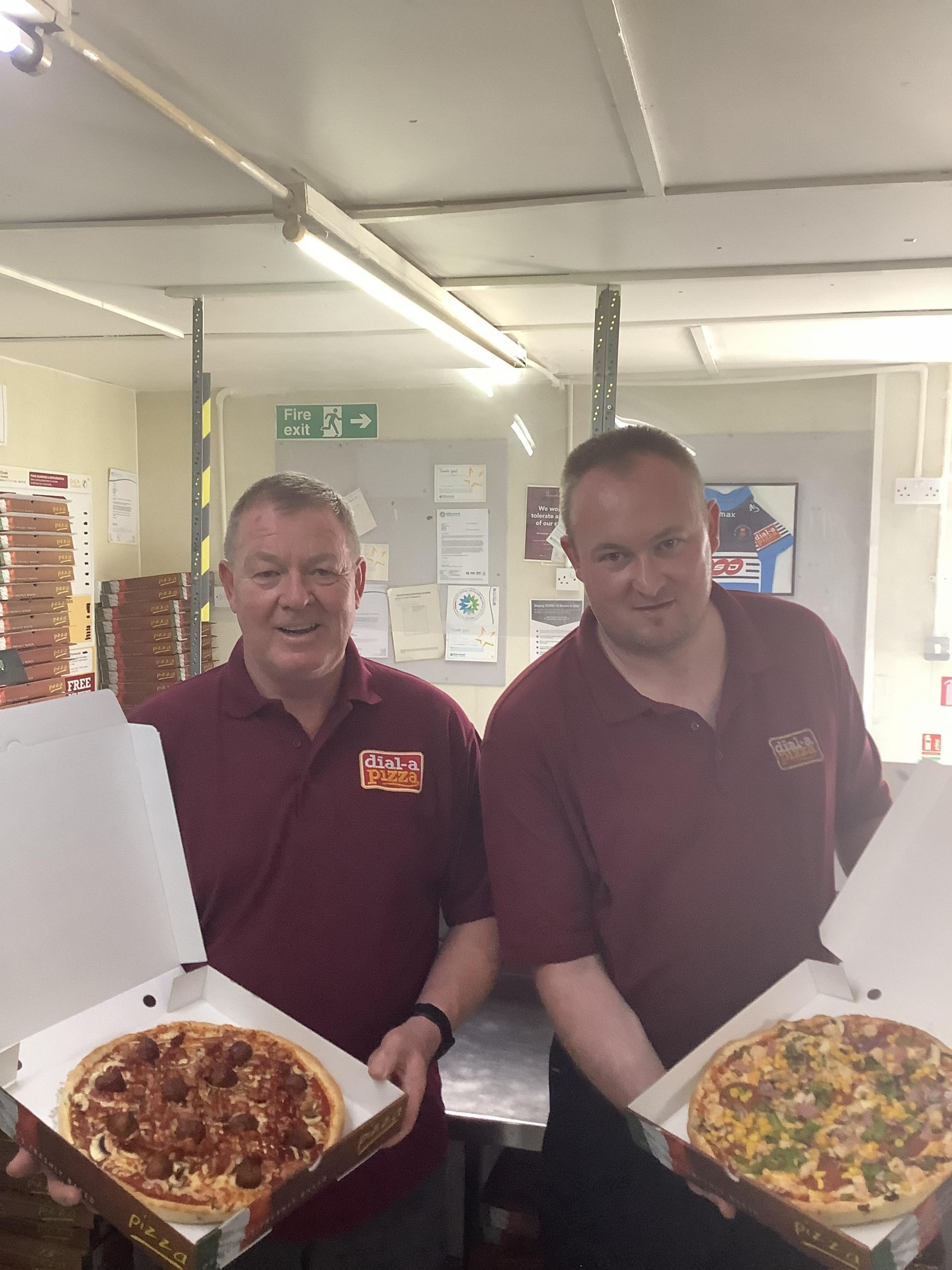 Owner John Jones (left) holds the mixed grill charity pizza and son Chris Jones has the Texan House special pizza