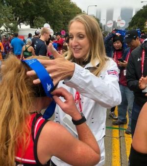 Colette Flaherty runs Chicago Marathon and receives medal from Paula Radcliffe